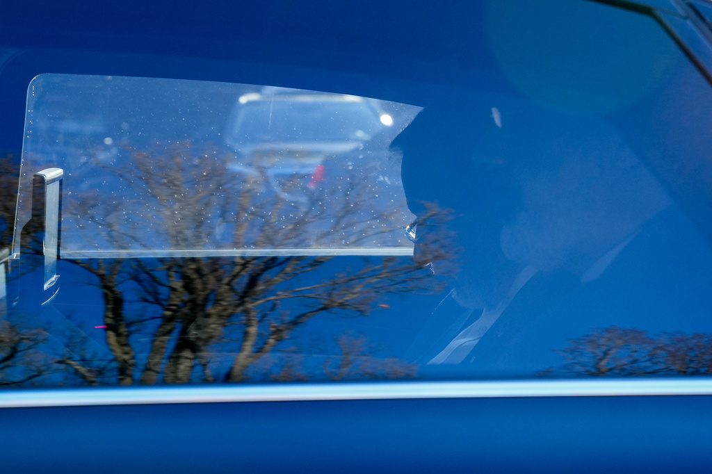 In this photo released by the Iranian Foreign Ministry, Iranian Foreign Minister Abbas Araghchi, second from right, sits at his car in Geneva, Switzerland, where Iran and the United States are holding a round of indirect talks, Thursday, Feb. 26, 2026. (Iranian Foreign Ministry via AP)