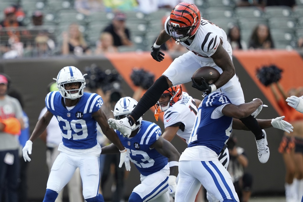 Cincinnati Bengals' Rashod Owens (12) leaps against Indianapolis Colts safety Trey Washington (41)during the second half of a preseason NFL football game, Saturday, Aug. 23, 2025, in Cincinnati. (AP Photo/Carolyn Kaster)