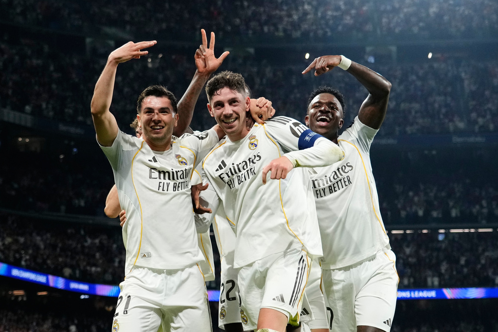 Real Madrid's Federico Valverde, center, celebrates after scoring his third goal during a first leg round of 16 Champions League soccer match between Real Madrid and Manchester City in Madrid, Spain, Wednesday, March 11, 2026. (AP Photo/Jose Breton)