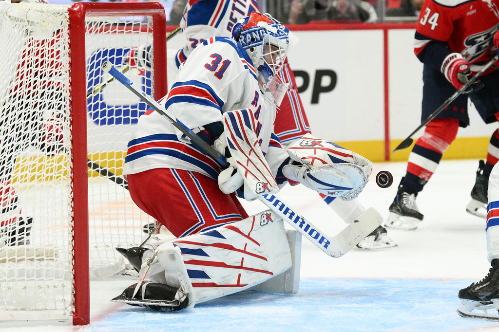 New York Rangers goaltender Igor Shesterkin (31) stops the puck during the first period of an NHL hockey game against the Washington Capitals, Friday, Oct. 9, 2026, in Washington. (AP Photo/Nick Wass)