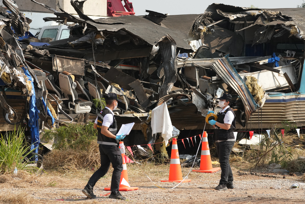 Forensic workers inspect the site of a train accident, a day after a construction crane fell into a passenger train in Nakhon Ratchasima province, Thailand, Thursday, Jan. 15, 2026. (AP Photo/Sakchai Lalit)