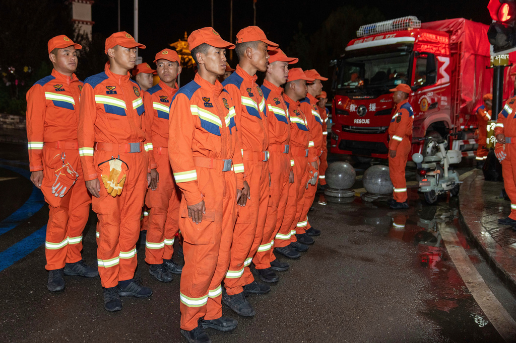In this photo released by Xinhua News Agency, rescuers prepare before heading to the mudslide-stricken area near Gyirong Port in Gyirong County, southwestern China's Tibet Autonomous Region early Thursday, Aug. 27, 2026. (Tenzing Nima Qadhup/Xinhua via AP)