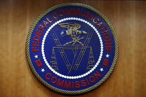 FILE - The seal of the Federal Communications Commission (FCC) is seen before an FCC meeting to vote on net neutrality, Dec. 14, 2017, in Washington. The FCC on Thursday, April 25, 2024 restored &ldquo;net neutrality&rdquo; rules that prevent broadband internet providers such as Comcast and AT&amp;T from favoring some sites and apps over others.. (AP Photo/Jacquelyn Martin, File)