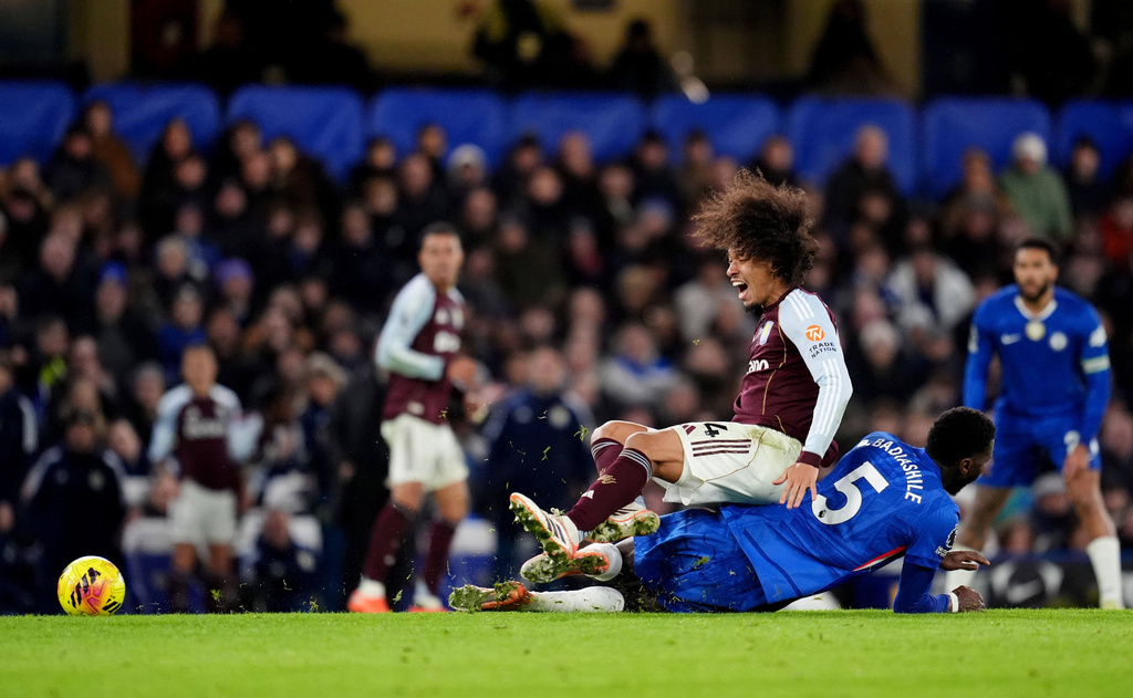 Chelsea's Benoit Badiashile, bottom, tackles Aston Villa's Boubacar Kamara, during the English Premier League soccer match between Chelsea and Aston Villa, at Stamford Bridge, in London, Saturday, Dec. 27, 2025. (Adam Davy/PA via AP)