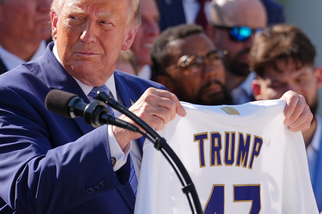 President Donald Trump holds up a Dodgers jersey during an event to honor the 2025 World Series champions Los Angeles Dodgers in the Rose Garden of the White House, Thursday, July 23, 2026, in Washington. (AP Photo/Julia Demaree Nikhinson)