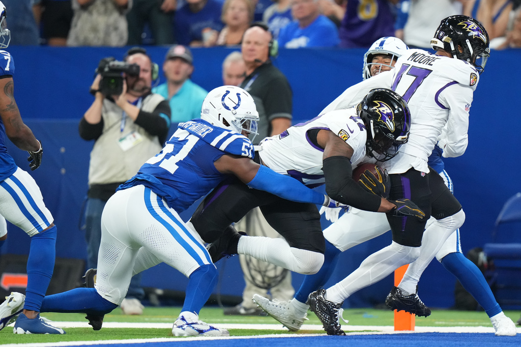Baltimore Ravens' Derrick Henry gets past Indianapolis Colts' Akeem Davis-Gaither for a touchdown during the first half of an NFL football game Sunday, Sept. 13, 2026, in Indianapolis. (AP Photo/AJ Mast)