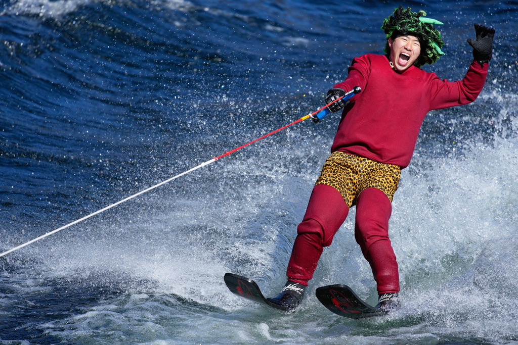 A student depicting "Oni", demon-like figures in Japanese folklore, skims across the water on water skis during the annual Bean Throwing Festival near Hakone Shrine in Hakone, Japan, Tuesday, Feb. 3, 2026. (AP Photo/Eugene Hoshiko)