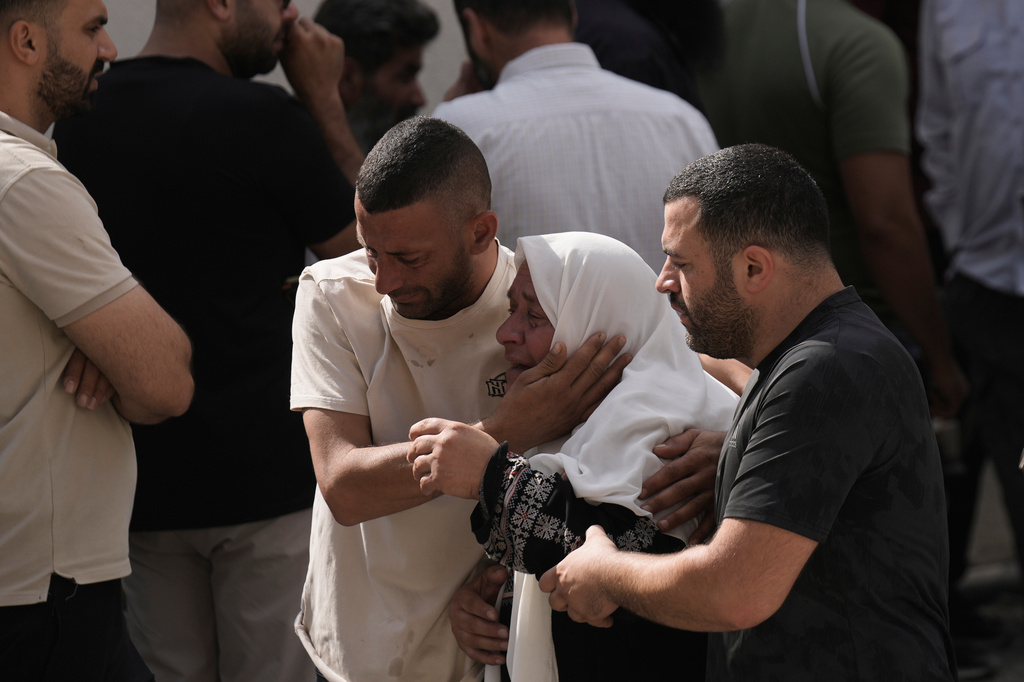 People mourn as the bodies of four Palestinians who, according to the Palestinian Health Ministry, were killed by Israeli forces near the village of Tell, arrive at Nablus Speciality Hospital in the West Bank city of Nablus, Friday, July 24, 2026. (AP Photo/Majdi Mohammed)