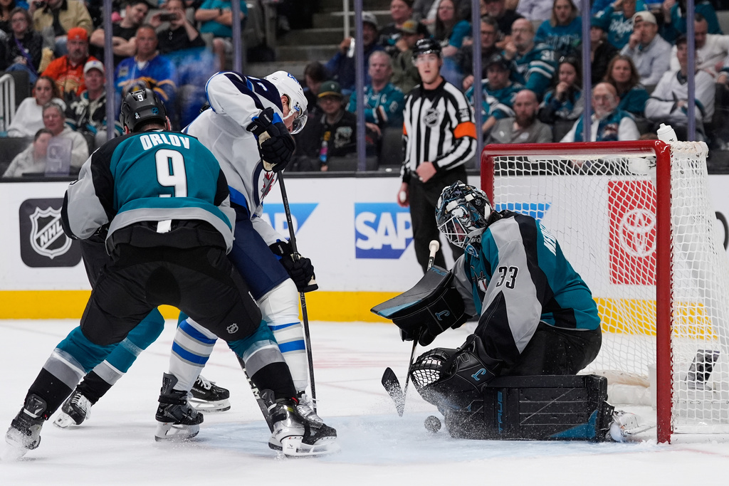 San Jose Sharks goaltender Alex Nedeljkovic (33) stops a shot during the second period of an NHL hockey game against the Winnipeg Jets, Sunday, March 1, 2026, in San Jose, Calif. (AP Photo/Godofredo A. Vásquez)