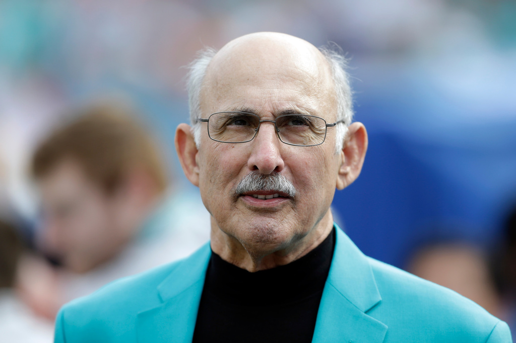 FILE - Former Miami Dolphins player Manny Fernandez waits to be inducted into the team's honor roll during half time of an NFL football game against the Minnesota Vikings, Dec. 21, 2014, in Miami Gardens, Fla. (AP Photo/Wilfredo Lee, File)