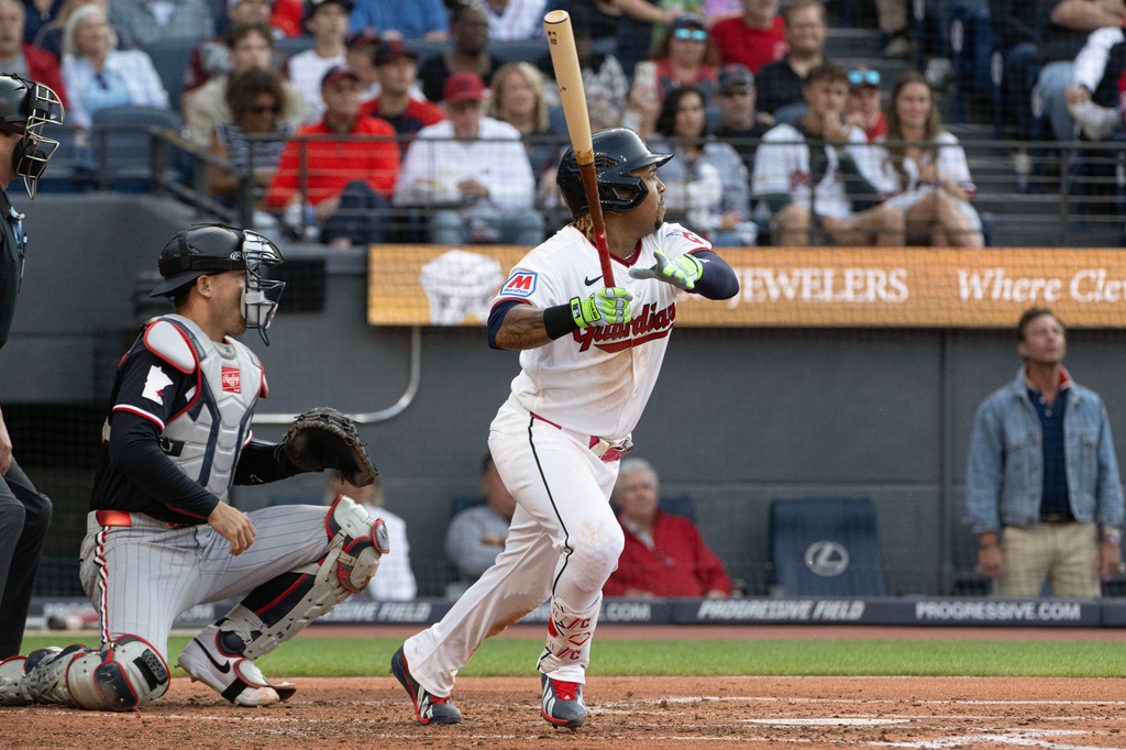 Cleveland Guardians' Jose Ramirez watches his RBI single off Minnesota Twins starting pitcher Bailey Ober as Alex Jackson looks on during the second inning of a baseball game, Wednesday, July 22, 2026, in Cleveland. (AP Photo/Phil Long)