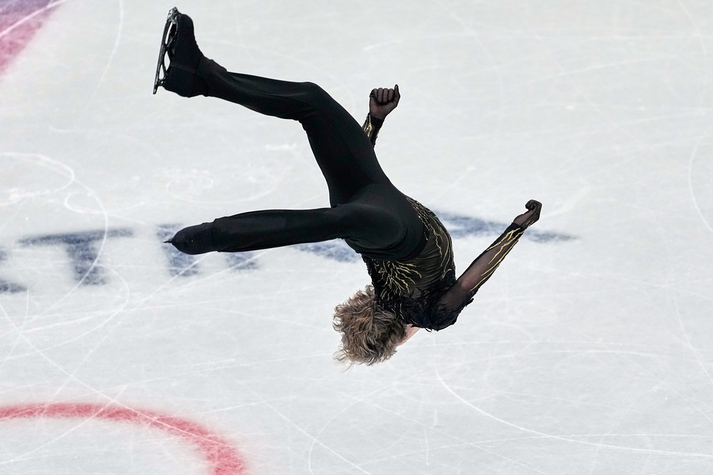 Ilia Malinin of the United States does a back flip while competing during the figure skating men's team event at the 2026 Winter Olympics, in Milan, Italy, Sunday, Feb. 8, 2026. (AP Photo/Natacha Pisarenko)