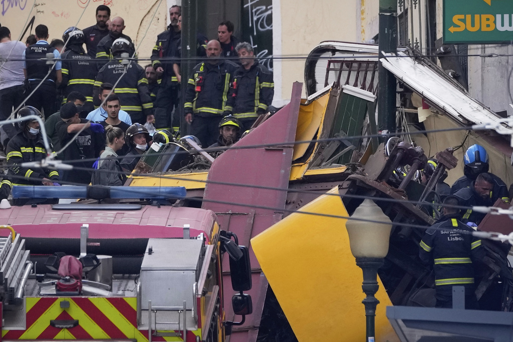 Emergency teams work at the site of a derailed electric streetcar in Lisbon, Portugal, Wednesday, Sept. 3, 2025. (AP Photo/Armando Franca)