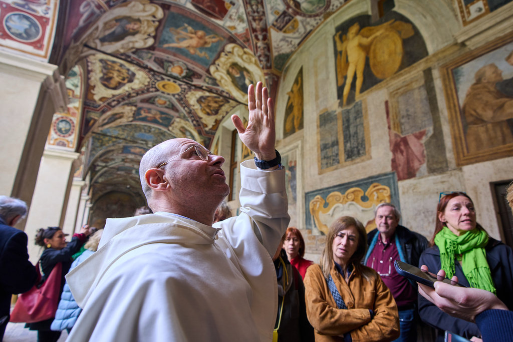 Friar Daniele Aucone, foreground, deputy director of the Basilica of Santa Maria sopra Minerva, guides journalists through the basilica’s cloister in Rome, Wednesday, March 18, 2026. (AP Photo/Domenico Stinellis)