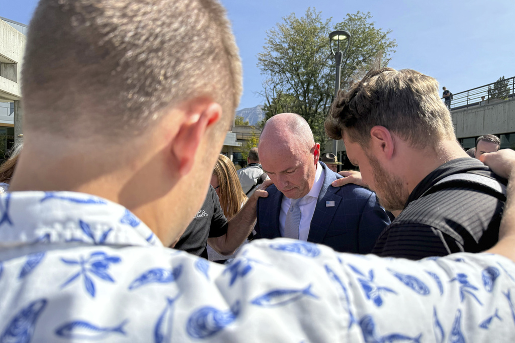 Utah Gov. Spencer Cox, center, prays with students at Utah Valley University Wednesday, Sept. 17, 2025, in Orem, Utah, during the first day back on campus after conservative activist Charlie Kirk was shot and killed on campus last week. (AP Photo/Jesse Bedayn)