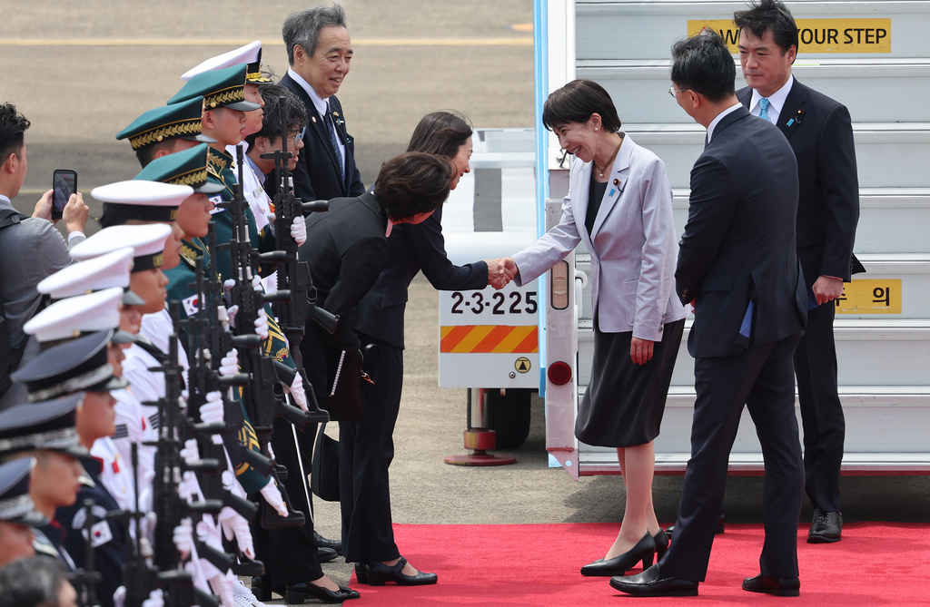 Japan's Prime Minister Sanae Takaichi, third from right, is greeted upon arrival at the Daegu International Airport in Daegu, South Korea, Tuesday, May 19, 2026. (Yoon Kwan-shick/Yonhap via AP)