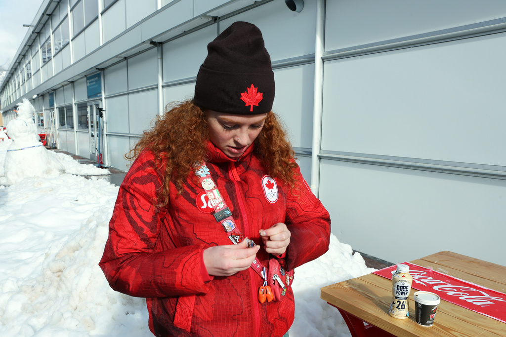 Kailey Allan, who is competing for Canada in the inaugural women's doubles luge looks at her favorite pins, at the Cortina Olympic Village, during the 2026 Winter Olympics, in Cortina d'Ampezzo, Italy, Thursday Feb. 5, 2026. (AP Photo/Jennifer McDermott)