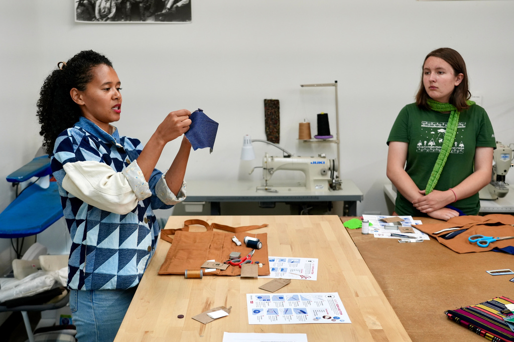 Levi’s employee Ella Fassler Clausen teaches during a sewing workshop at a Levi's retail store in downtown San Francisco, Wednesday, July 22, 2026. (AP Photo/Terry Chea)