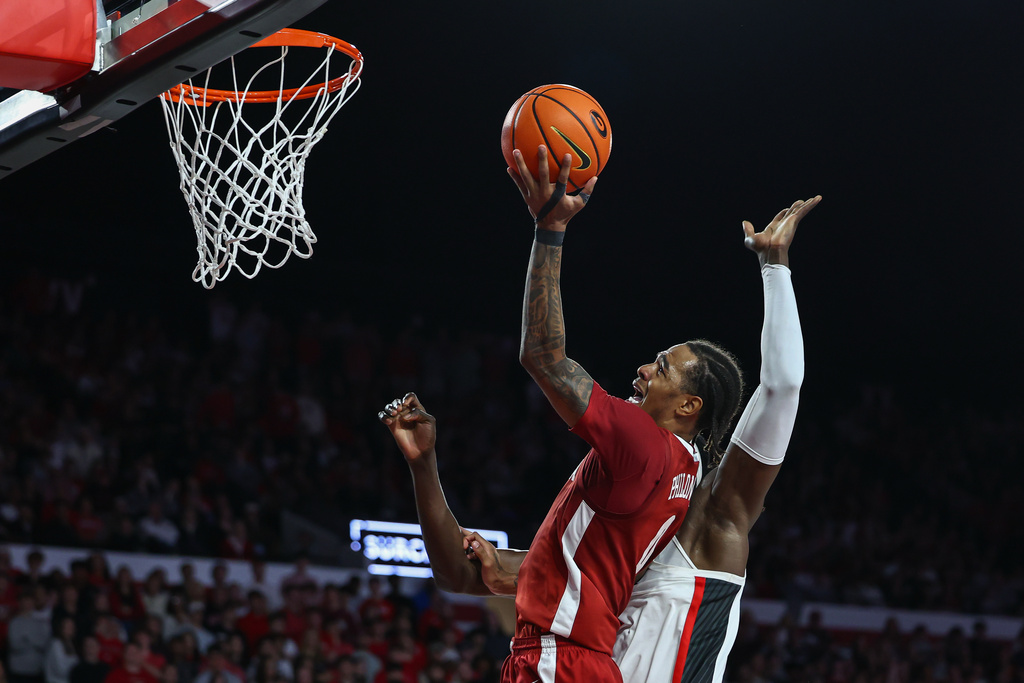Alabama guard Labaron Philon, left, shoots against Georgia center Somto Cyril, right, during the first half of an NCAA college basketball game, Tuesday, March. 3, 2026, in Athens, Ga. (AP Photo/Colin Hubbard)