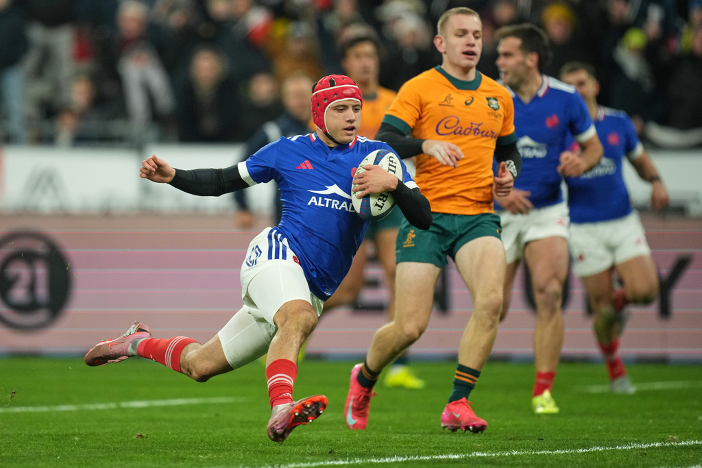France's Louis Bielle-Biarrey crosses the line to score a try during the rugby union Nations Series match between France and Australia in Saint-Denis, outside Paris, Saturday, Nov. 22, 2025. (AP Photo/Christophe Ena)
