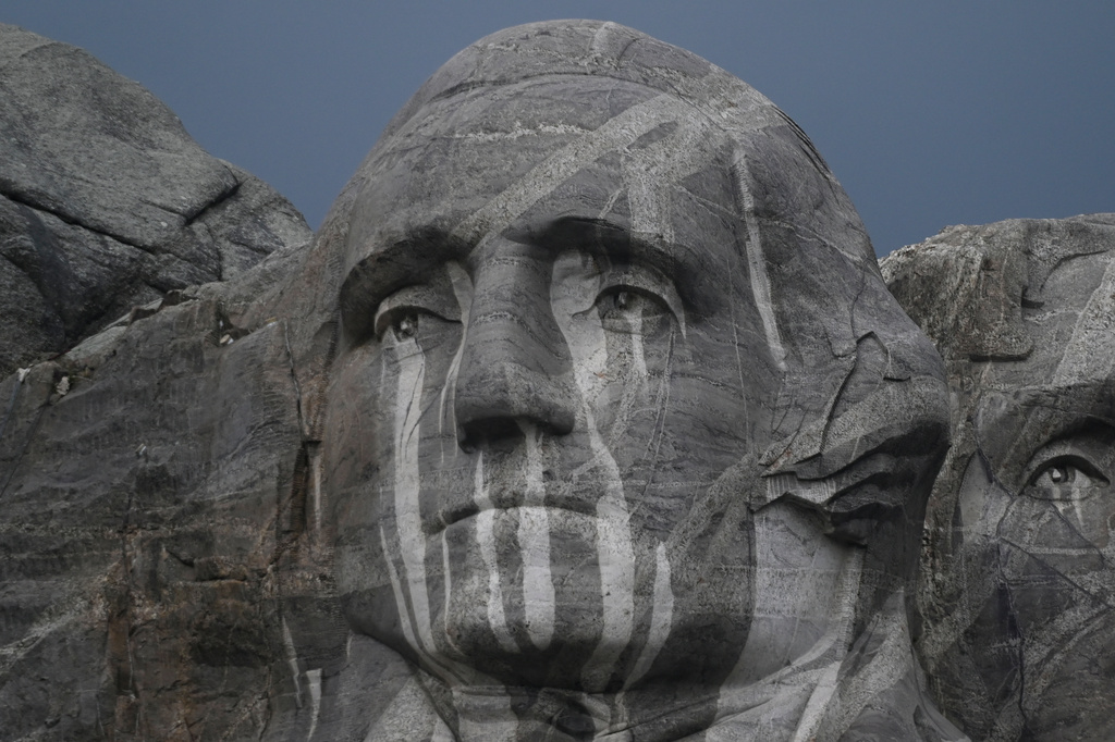 Rain runs down a sculpture of George Washington at Mount Rushmore National Memorial, Friday, July 3, 2026, in Keystone, S.D. (AP Photo/Matt Gade)