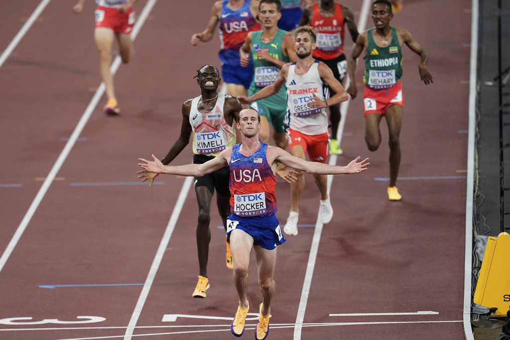 United States' Cole Hocker crosses the finish line before Belgium's Isaac Kimeli in the men's 5,000 meters final at the World Athletics Championships in Tokyo, Sunday, Sept. 21, 2025. (AP Photo/Abbie Parr)