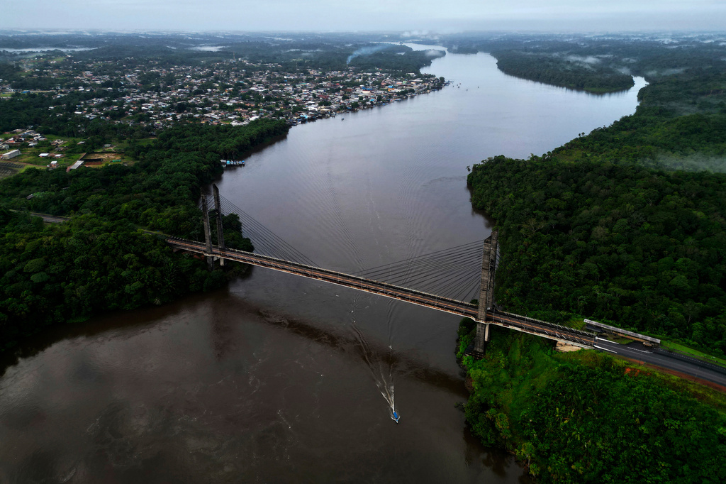 View of the Franco-Brazilian Binational Bridge, over the Oiapoque River, connecting the city of Oiapoque, in the background, with French Guiana, during sunrise in the city of Oiapoque, Amapa state, Brazil, Tuesday, March 10, 2026. (AP Photo/Eraldo Peres)