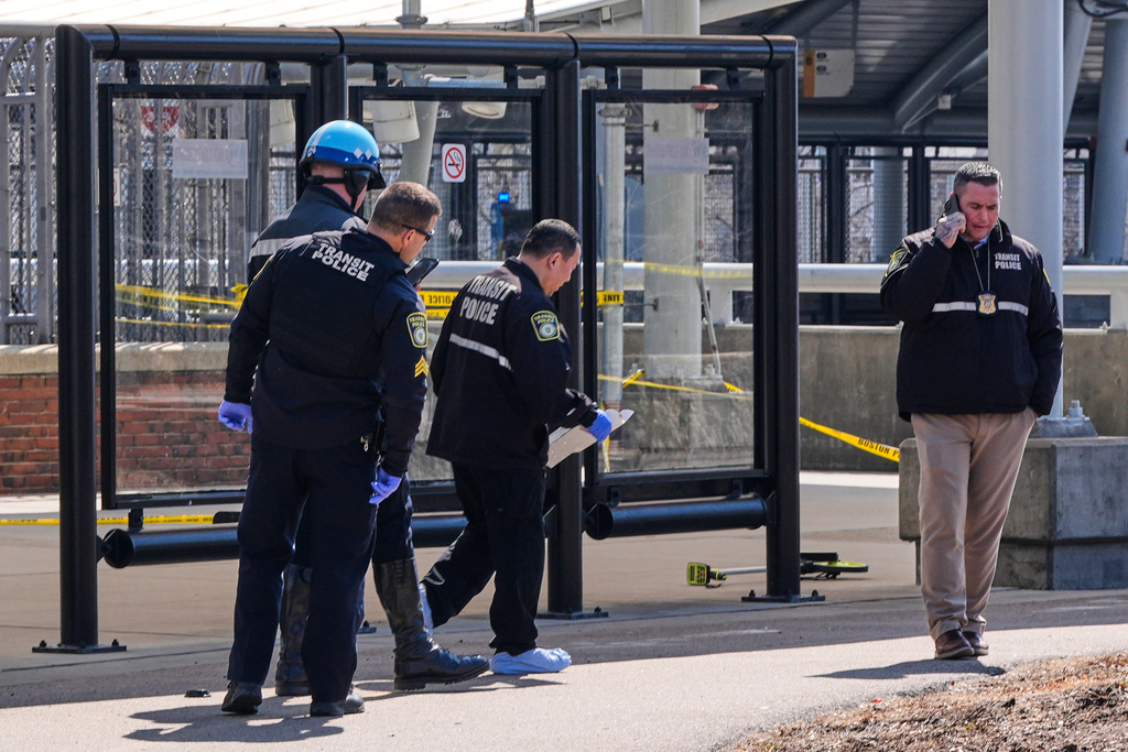 Law enforcement officials work a crime scene at the Forest Hills train station in the Jamaica Plain neighborhood, Friday, March 20, 2026, in Boston. (AP Photo/Charles Krupa)