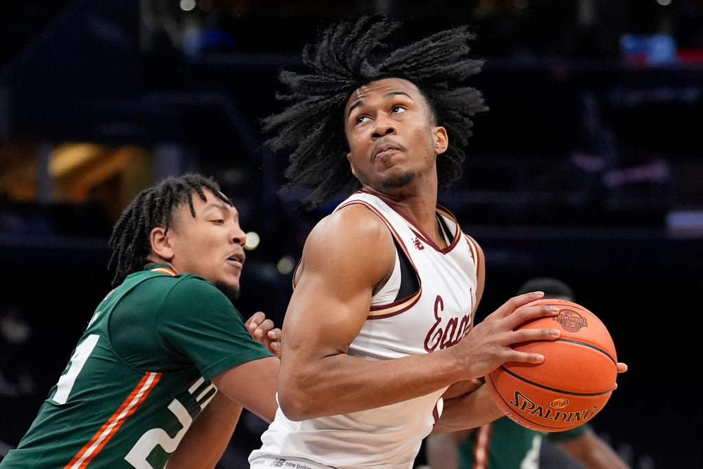 FILE - Boston College guard Donald Hand Jr. (13) goes up against Miami guard Nijel Pack (24) during the second half of the Atlantic Coast Conference NCAA college basketball tournament Tuesday, March 12, 2024, in Washington. (AP Photo/Alex Brandon, File)