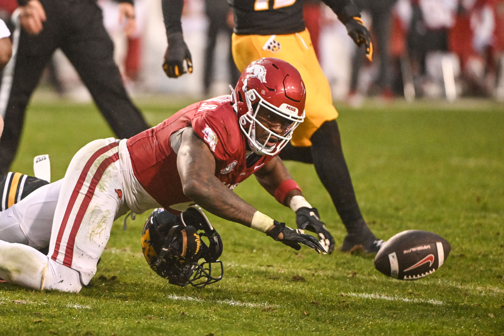 Arkansas running back Mike Washington Jr. fumbles as he runs against Missouri during the second half of an NCAA college football game Saturday, Nov. 29, 2025, in Fayetteville, Ark. (AP Photo/Michael Woods)