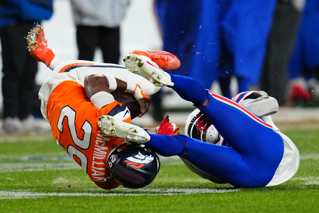 Denver Broncos cornerback Ja'quan McMillian (29) intercepts a pass intended for Buffalo Bills wide receiver Brandin Cooks (18) during overtime of an NFL divisional round playoff football game, Saturday, Jan. 17, 2026, in Denver. (AP Photo/Jack Dempsey)