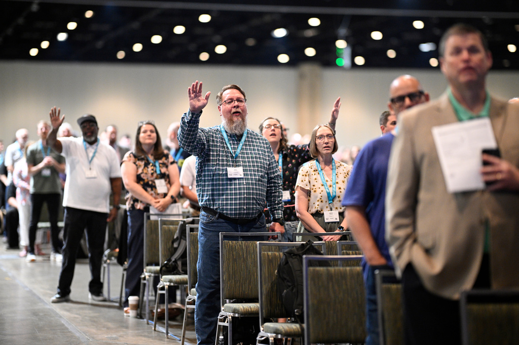 Attendees worship during the annual meeting of the Southern Baptist Convention, Tuesday, June 9, 2026, in Orlando, Fla. (AP Photo/Phelan M. Ebenhack)