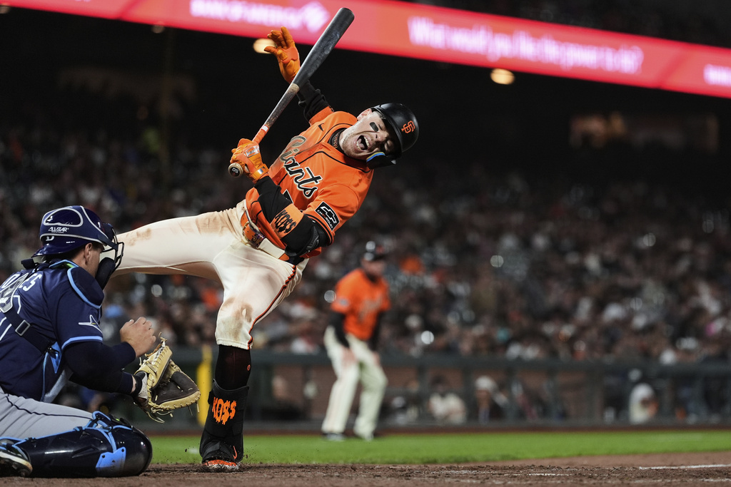 San Francisco Giants' Christian Koss, right, reacts next to Tampa Bay Rays catcher Nick Fortes after being hit by a pitch during the eighth inning of a baseball game Friday, Aug. 15, 2025, in San Francisco. (AP Photo/Godofredo A. Vásquez)
