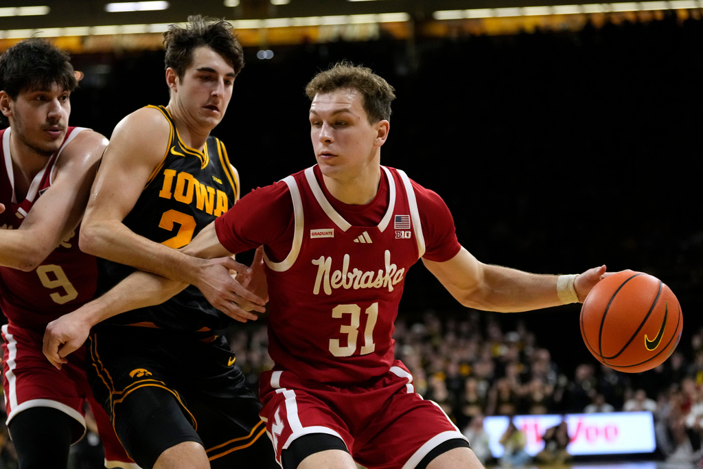 Nebraska guard Cale Jacobsen (31) drives past Iowa guard Tate Sage (24) during the first half of an NCAA college basketball game, Tuesday, Feb. 17, 2026, in Iowa City, Iowa. (AP Photo/Charlie Neibergall)