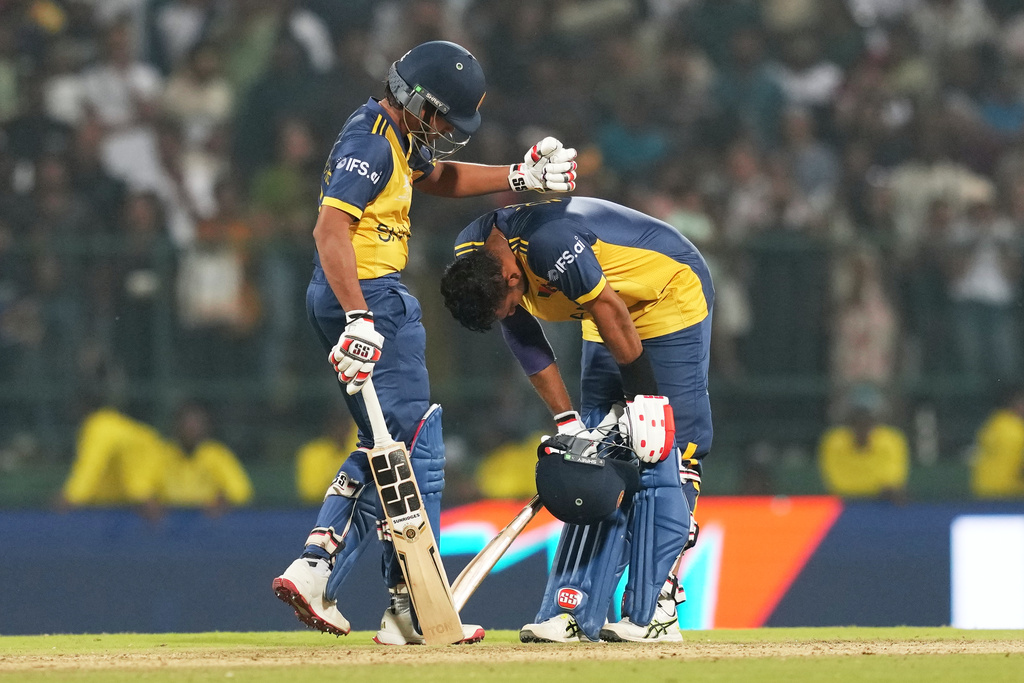 Sri Lanka's captain Dasun Shanaka, right, is consoled by teammate Dunith Wellalage after losing the T20 World Cup cricket match against Pakistan in Pallekele, Sri Lanka, Saturday, Feb. 28, 2026. (AP Photo/Eranga Jayawardena)