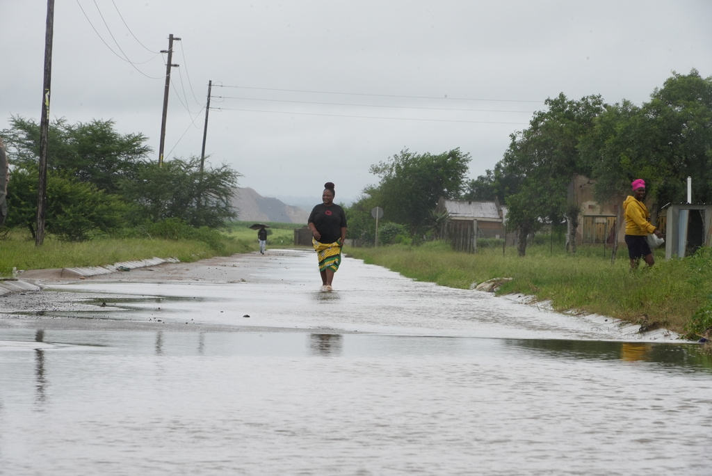 People walk through floodwaters in Nkomazi, Mpumalanga Province, South Africa, on Friday, Jan. 16, 2026. (AP Photo/Alfonso Nqunjana)