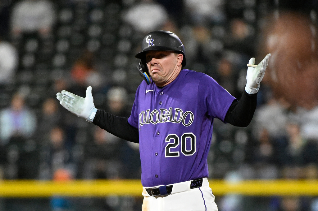Colorado Rockies' Troy Johnston shrugs toward his team's dugout after hitting an RBI double in the fifth inning of a baseball game against the Houston Astros, Monday, April 6, 2026, in Denver. (AP Photo/Geneva Heffernan)