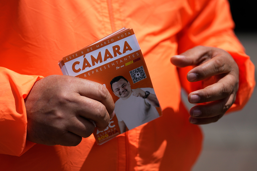 Congressman Carlos Carreño Marín, who goes by Sergio Marin, of the Comunes party, campaigns for reelection ahead of legislative elections in Bogota, Colombia, Thursday, Feb. 26, 2026. (AP Photo/Fernando Vergara)