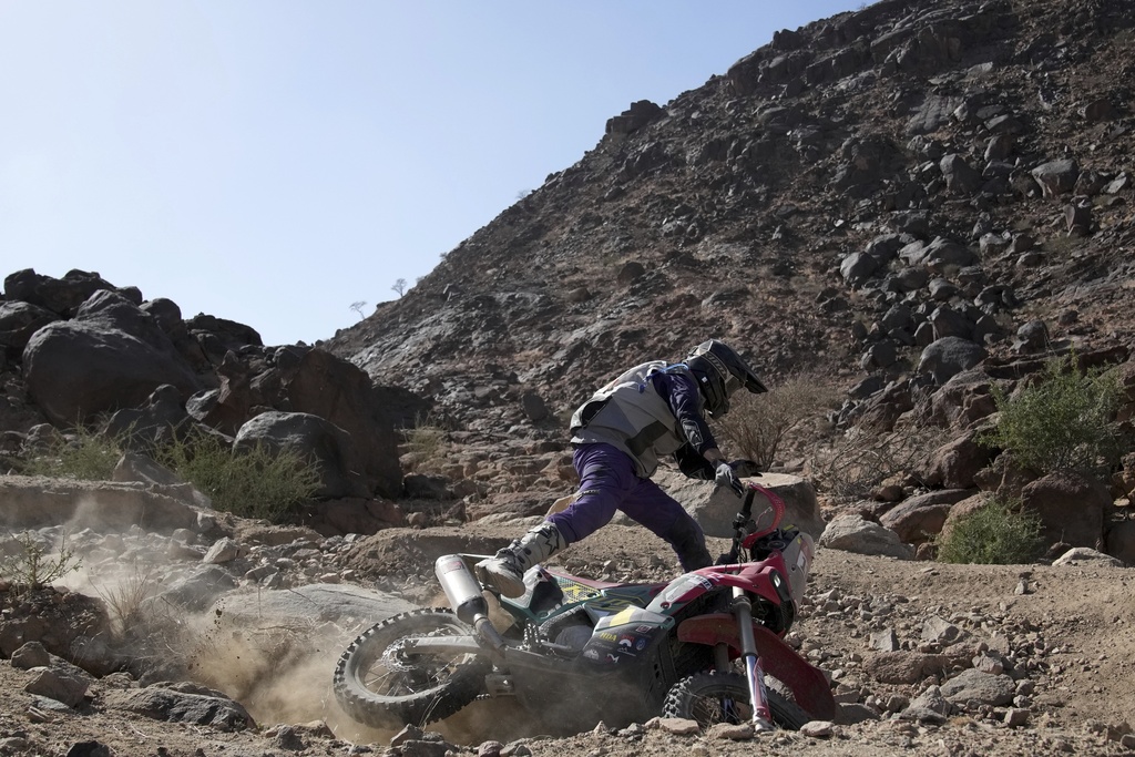 Rider Jordan Strachan falls as he competes during stage one of the Dakar Rally with start and finish in Bisha, Saudi Arabia, Saturday, Jan. 4, 2025. (AP Photo/Christophe Ena)