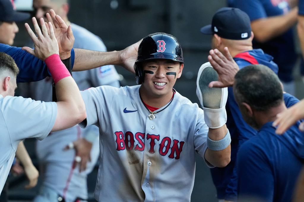 Boston Red Sox's Tsung-Che Cheng of Taiwan, celebrates with teammates after scoring on a one-run double by Ceddanne Rafaela during the third inning of a baseball game against the Chicago White Sox in Chicago, Wednesday, July 8, 2026. (AP Photo/Nam Y. Huh)
