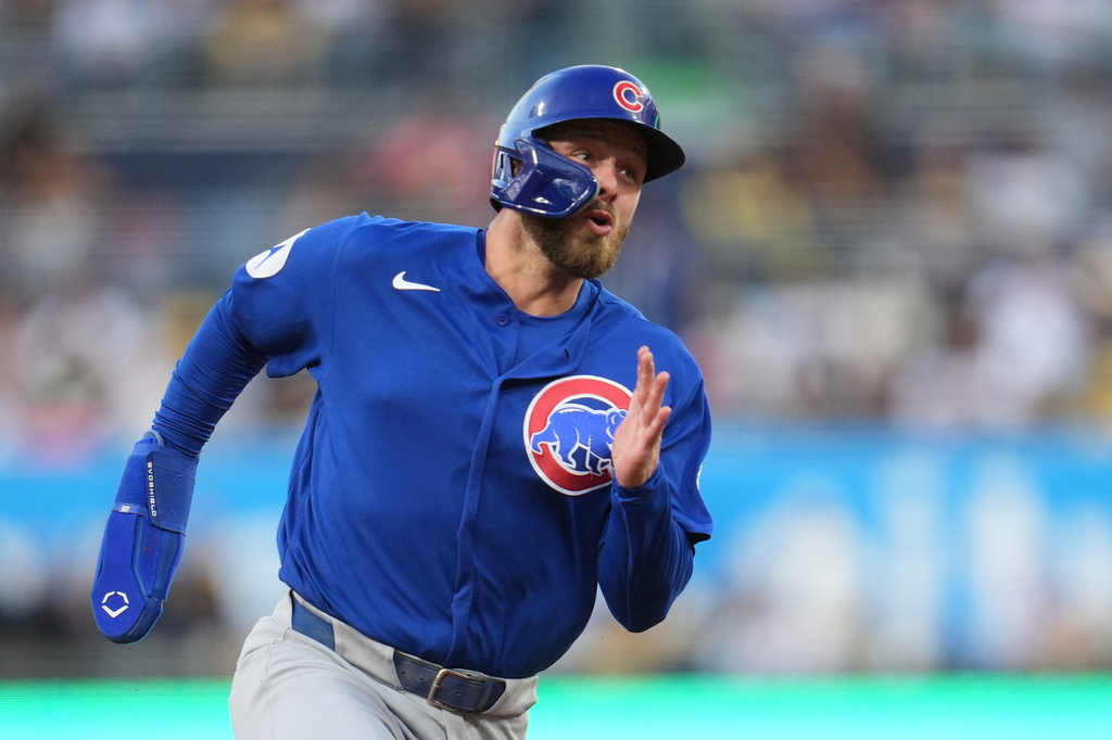 Chicago Cubs' Michael Busch rounds third base on his way to scoring from first base off a two-RBI double by Dansby Swanson during the second inning of a baseball game Tuesday, April 28, 2026, in San Diego. (AP Photo/Gregory Bull)