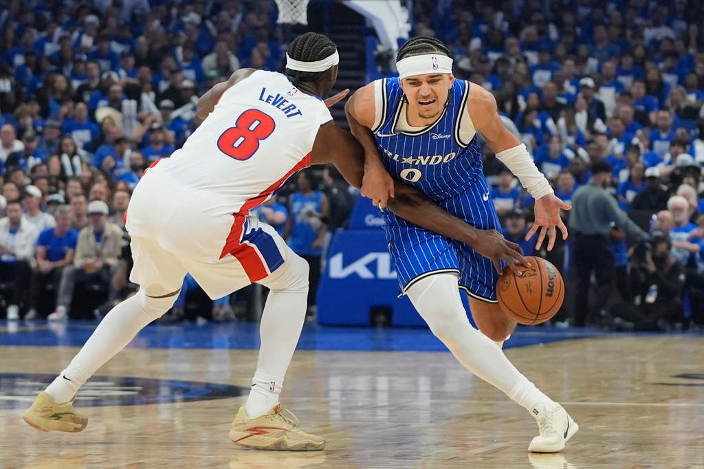Detroit Pistons guard Caris LeVert (8) strips the ball from Orlando Magic guard Anthony Black (0) during the second half in Game 4 of a first-round NBA basketball playoff series, Monday, April 27, 2026, in Orlando, Fla. (AP Photo/John Raoux)