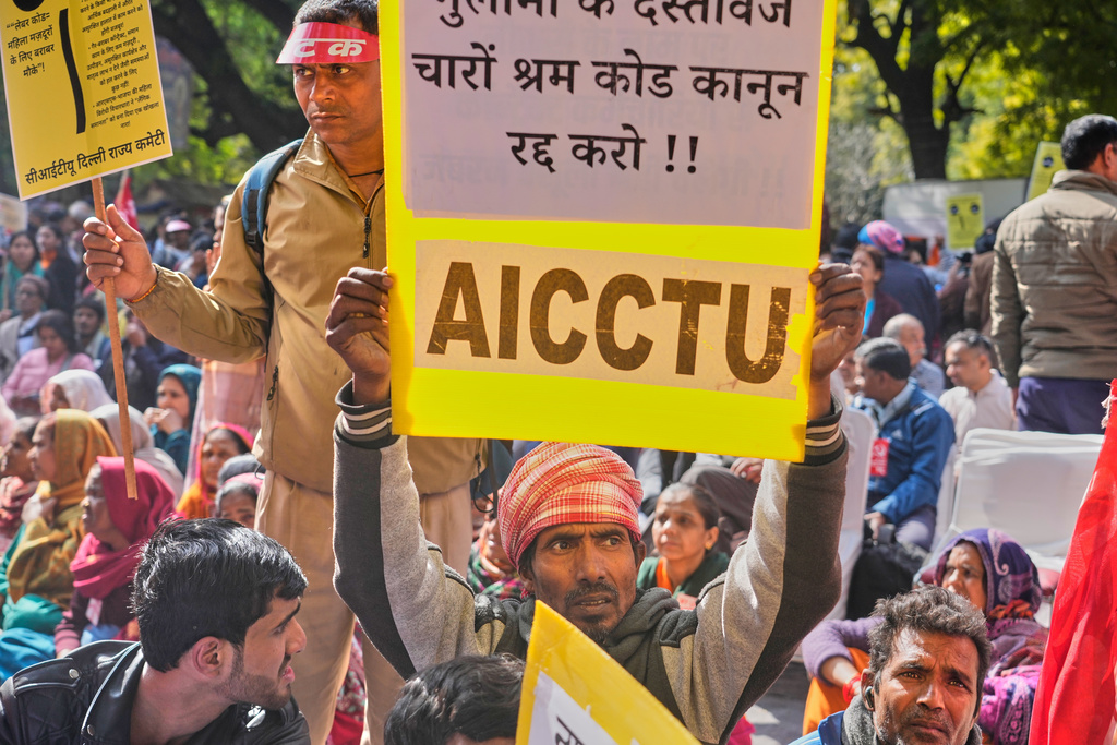 Members of trade unions hold banners during a nationwide strike to protest an interim trade deal with the United States, saying the agreement undermines the interests of farmers, small businesses and workers in New Delhi, India, Thursday, Feb. 12, 2026. (AP Photo/Manish Swarup)