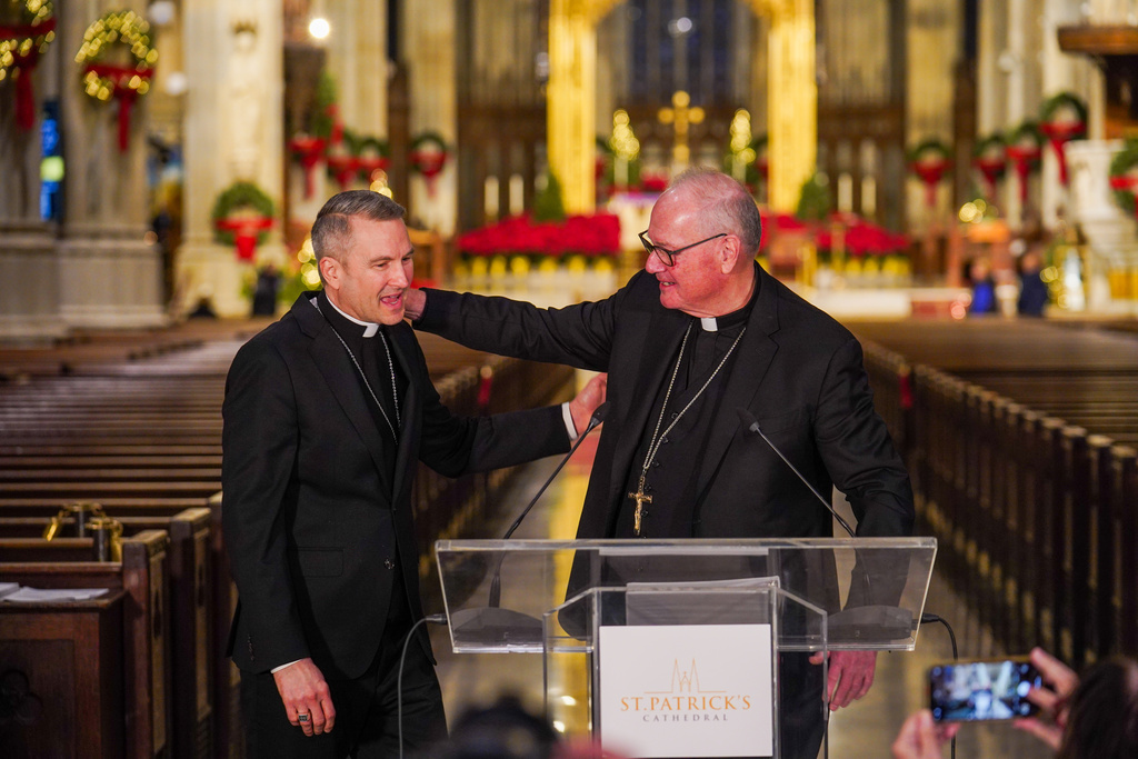 New York Archbishop, Timothy Dolan, right, greets Bishop Ronald Hicks during a news conference, Thursday, Dec.18, 2025 in New York. (AP Photo/Ryan Murphy)
