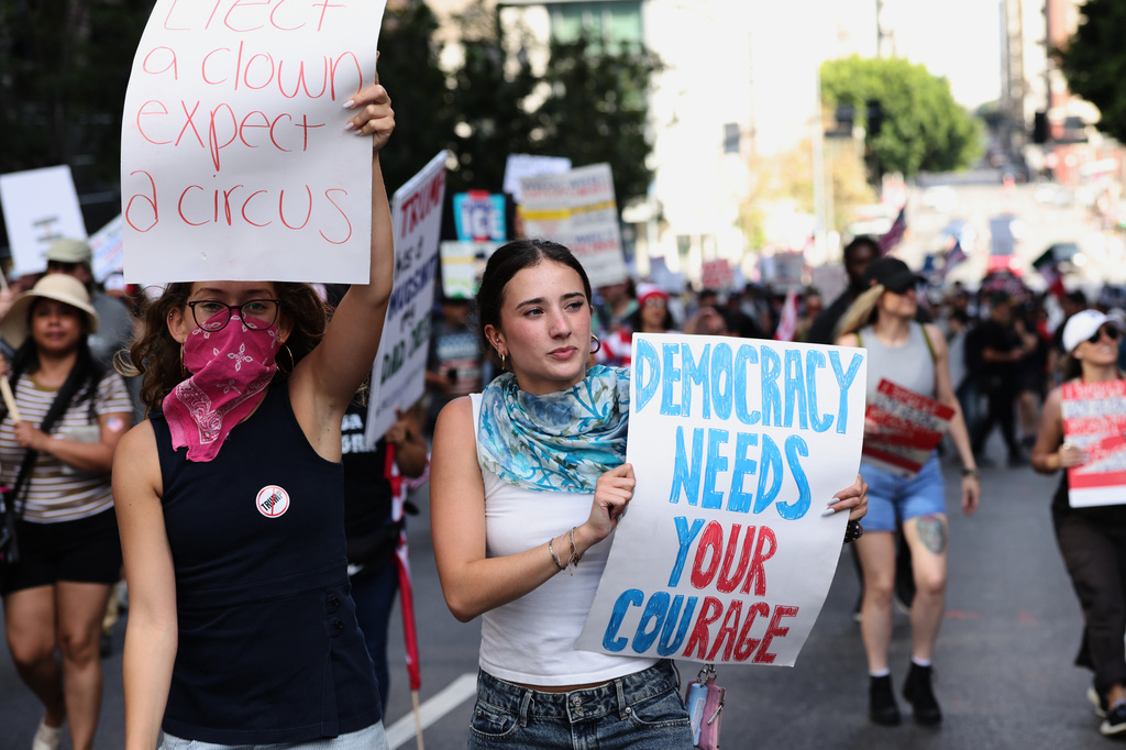 Demonstrators march through downtown Los Angeles during a "No Kings" protest Saturday, March 28, 2026. (AP Photo/Jill Connelly)