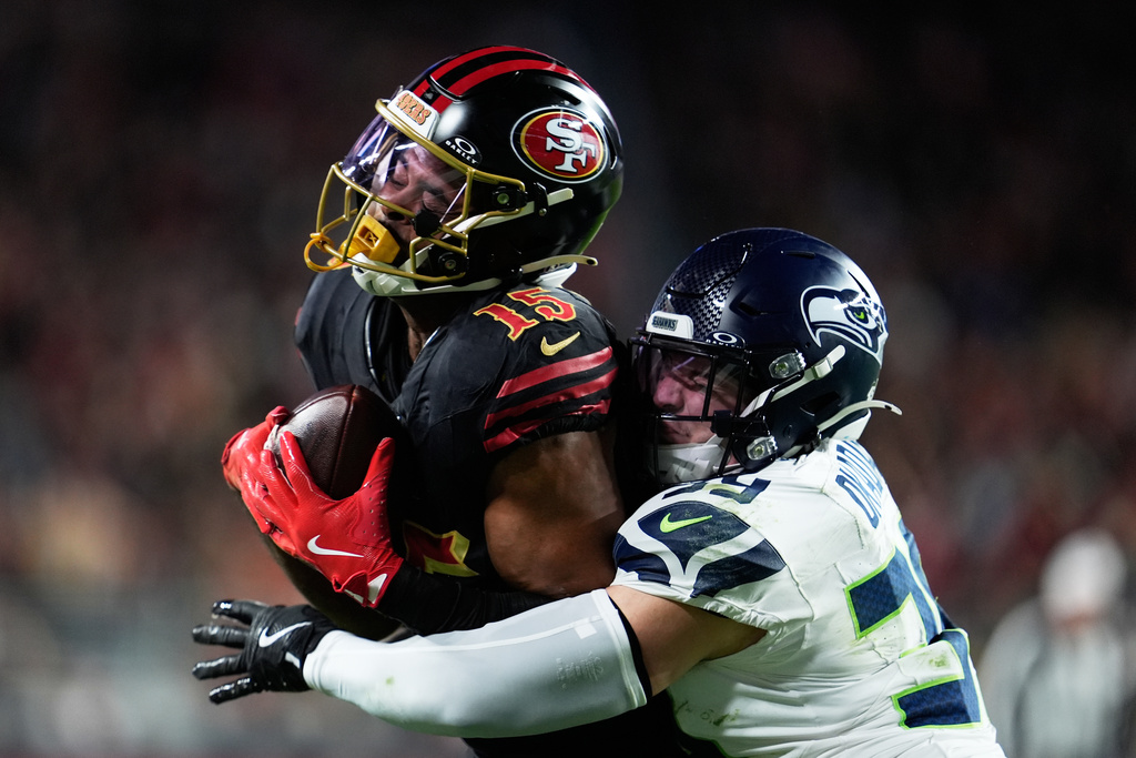San Francisco 49ers wide receiver Jauan Jennings (15) catches a pass against Seattle Seahawks safety Ty Okada during the second half of an NFL football game in Santa Clara, Calif., Saturday, Jan. 3, 2026. (AP Photo/Godofredo A. Vásquez)