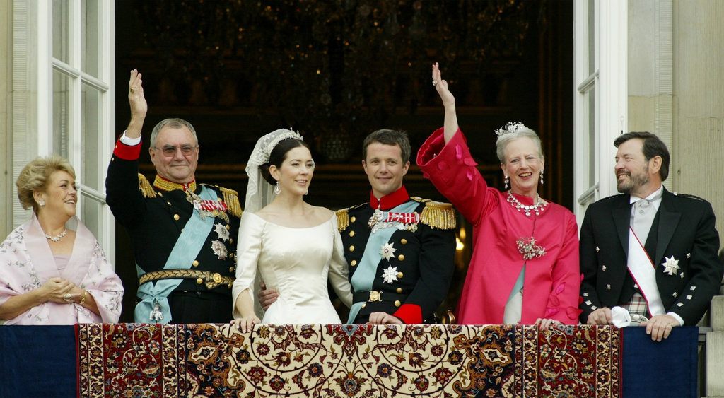 FILE - Denmark's Crown Prince Frederik and Crown Princess Mary, center, pose with parents Susan Moody, Prince Hendrik, Queen Margrethe and John Donaldson, from left, on the Amalienborg Palace balcony following the wedding ceremony in Copenhagen on May 14, 2004. (AP Photo/Heribert Proepper, File)