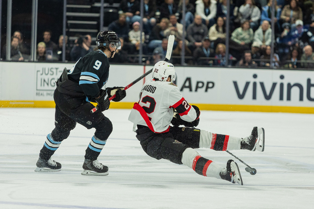 Ottawa Senators right wing Michael Amadio (22) goes down after the puck against Utah Mammoth center Clayton Keller (9) during the second period of an NHL hockey game Wednesday, Jan. 7, 2026, in Salt Lake City. (AP Photo/Melissa Majchrzak)