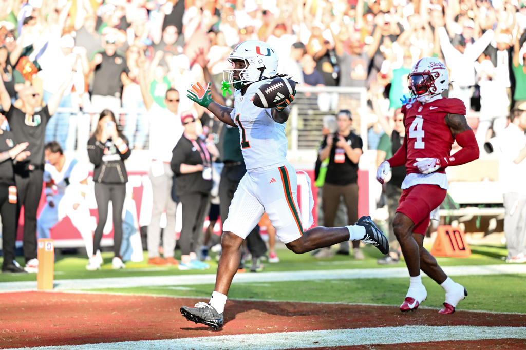 Miami wide receiver Malachi Toney (1) scores a touchdown against Stanford during the first half of an NCAA college football game Friday, Sept. 4, 2026, in Stanford, Calif. (AP Photo/Thien-An Troung)