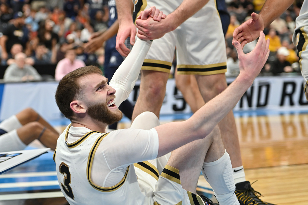 Purdue's Braden Smith (3) is helped up by teammates during the first half in the first round of the NCAA college basketball tournament against Queens University, Friday, March 20, 2026, in St. Louis. (AP Photo/Ali Overstreet)